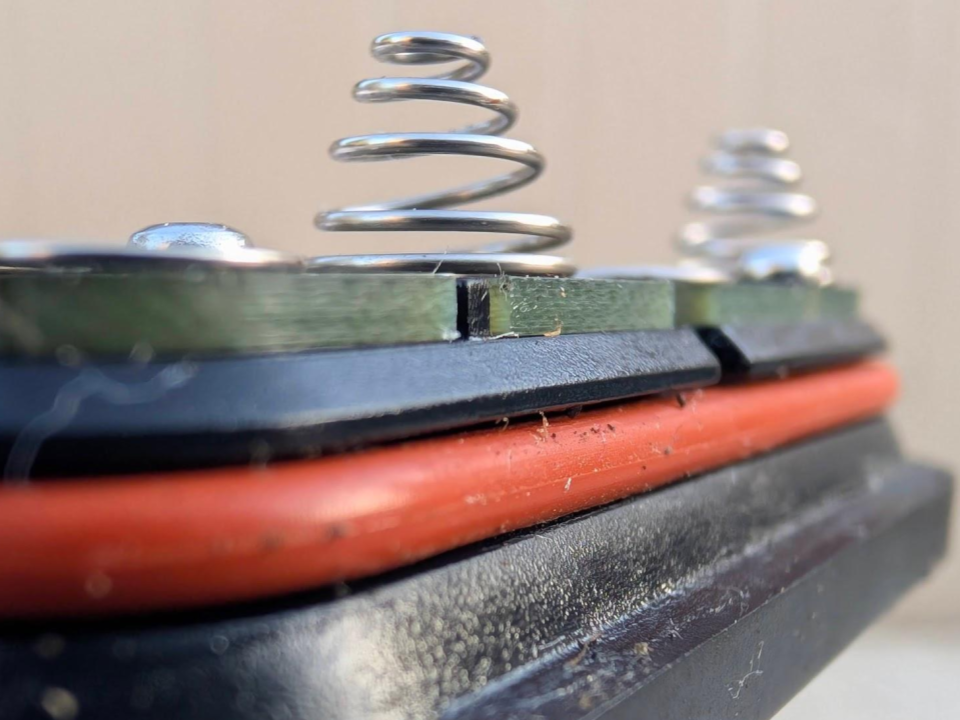 A close-up view of a weathered O-ring and a battery cap showing significant dirt and debris buildup after one year of use.