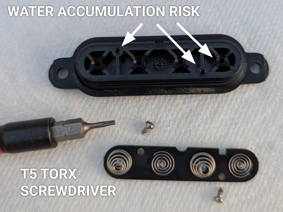 A view of the battery spring board being removed with a T5 Torx screwdriver, highlighting the small ventilation holes that must remain dry and free of liquid