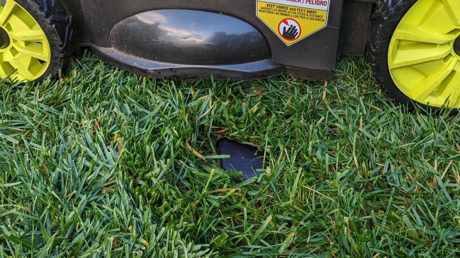 Image showing GeoDrops Droplet installed in the middle of a lawn, and can safely be run over by a lawn mower.